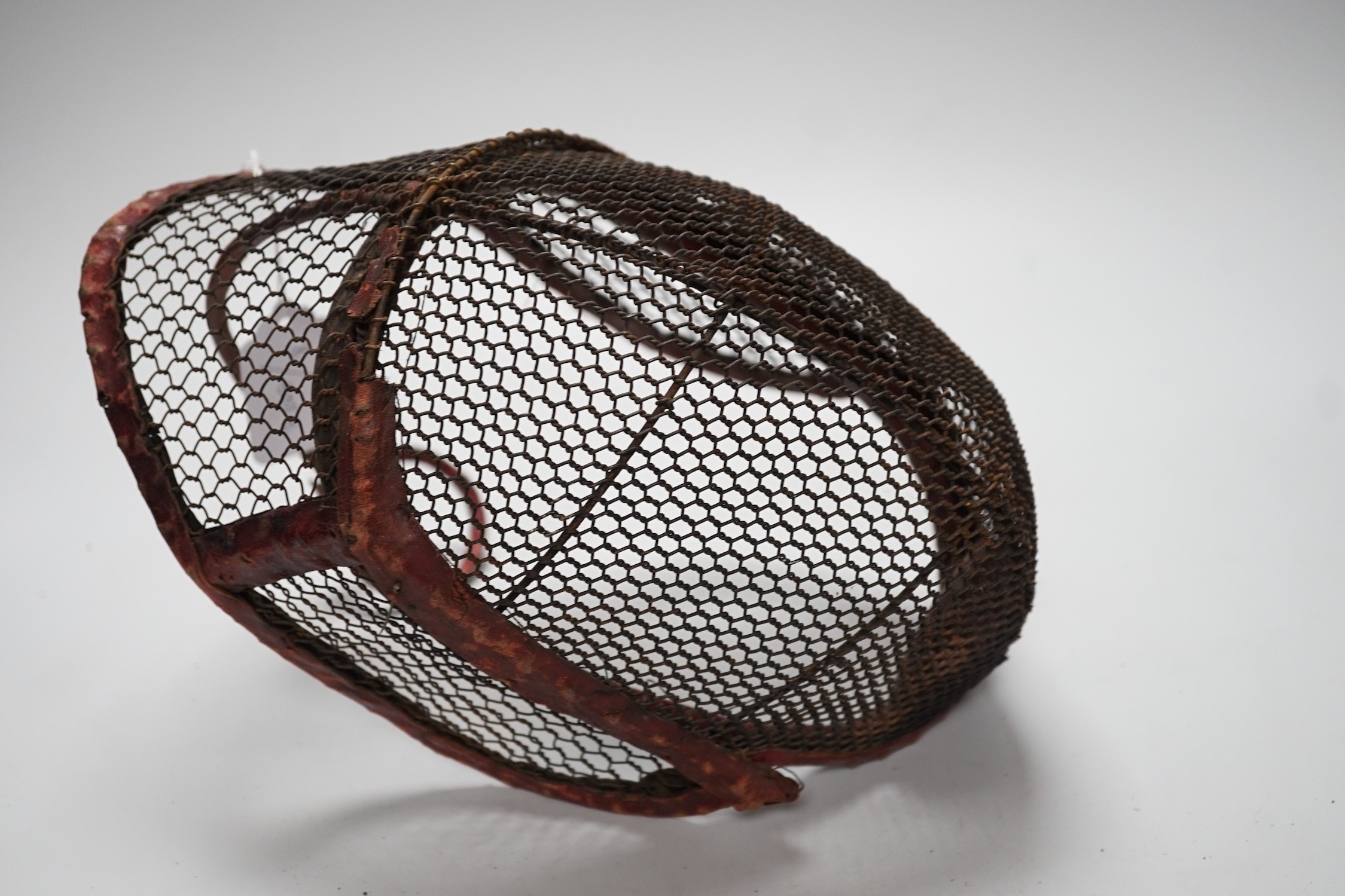 A fencing face mask, 30cms wide